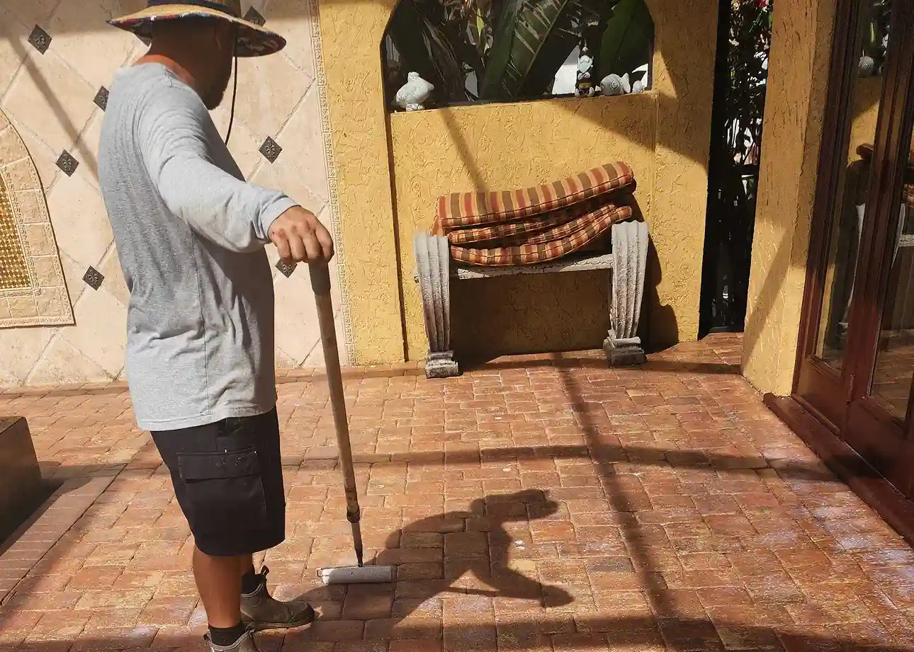 Technician pressure washing pavers as part of maintenance service in Punta Gorda, FL